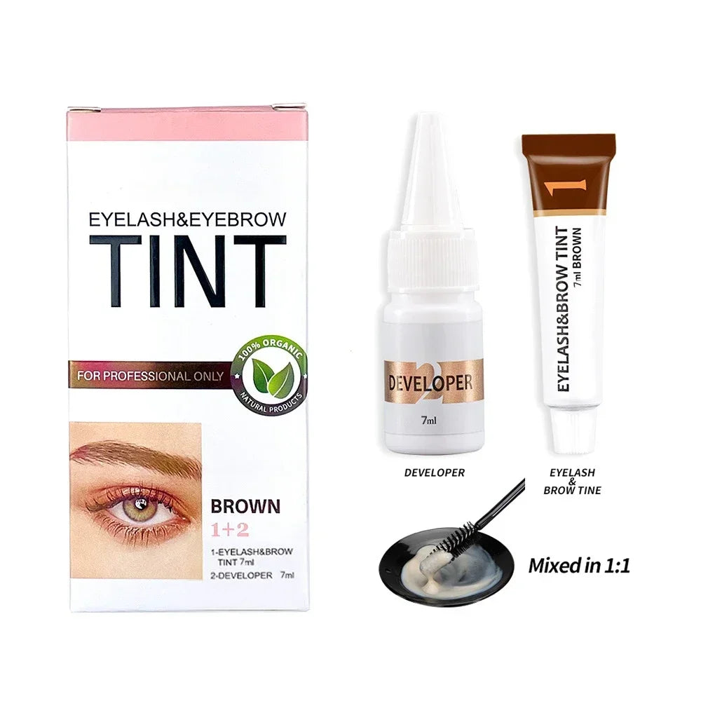 Eyelash and eyebrow tinting kit with box, developer bottle, and applicator on a white background.